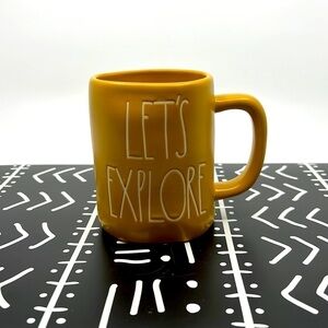 Rae Dunn "Let's Explore" Mug in Gold and White.